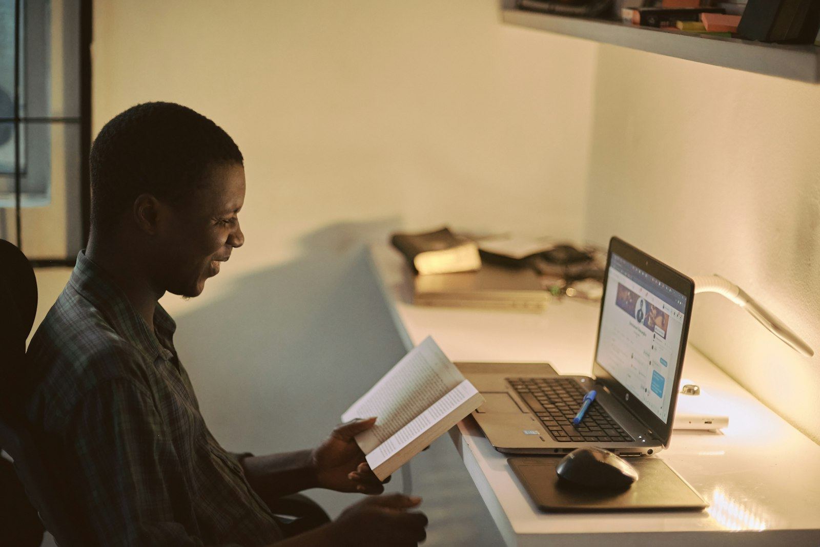 Consultant reviewing documentation beside a laptop