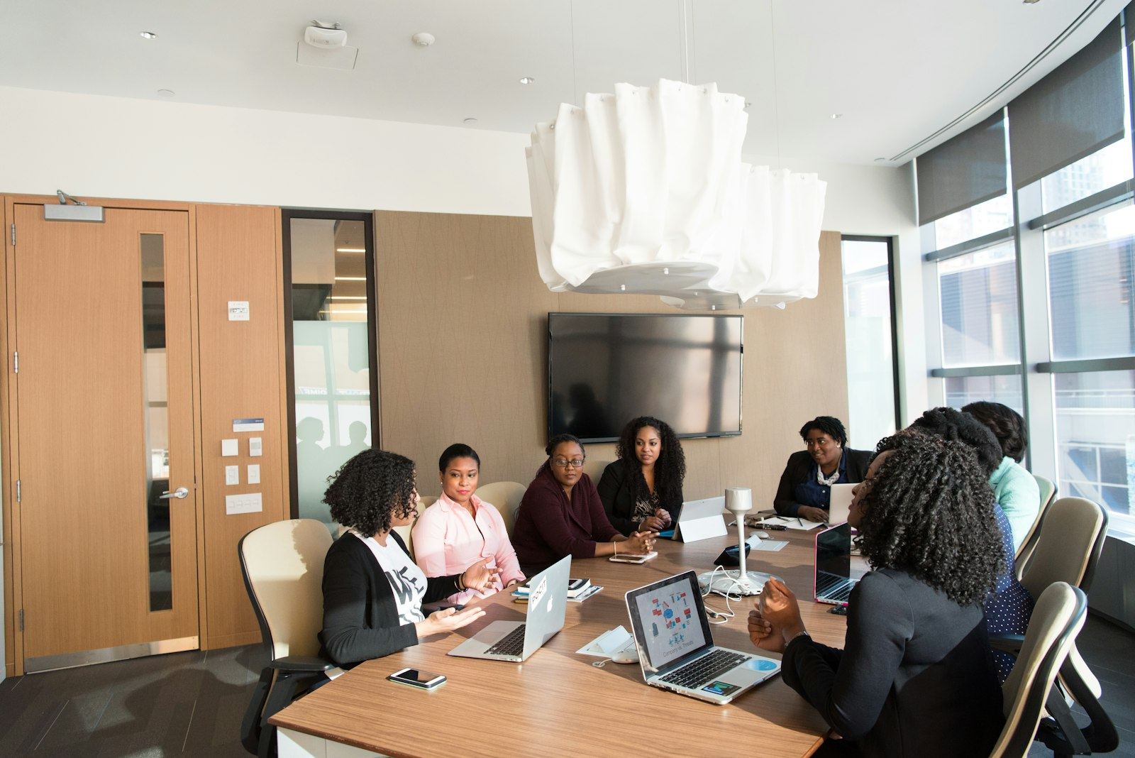 Consultants in a project workshop around a boardroom table